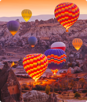 Image of hot air balloons flying over the landscape of Cappadocia